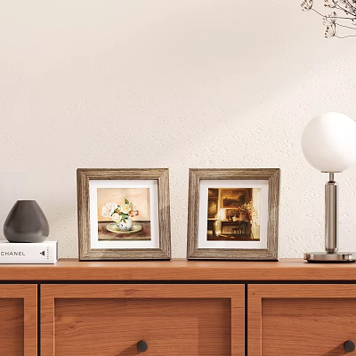Two Wooden Frames with Floral Art and Interior Scene on Wooden Cabinet with Table Lamp 3d model