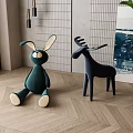 Green Rabbit And Black Deer Plush Stuffed Toys On Herringbone Wooden Floor