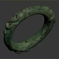 Green Circular Bronze Sculpture Featuring Intricate Decorative Carvings On Surface