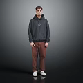 Man Wearing Dark Gray Hoodie With Brown Pants And White Shoes On Gray Background