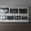 Multiple Samsung Televisions with Time Display and Black Hole Image on Wall