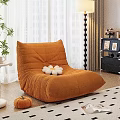 Soft Orange Bean Bag Chair With White Flower Decoration And Green Plants By Window Curtains