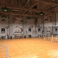 Bright Fitness Dance Studio with Wooden Floor Barre Green Pendant Lights and Exposed Brick Walls