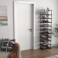 Black Multi Tiered Shoe Rack With Various Shoes In Living Room With Sofa And Painting