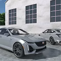 Silver Luxury Sedans Parked By Modern Building With Large Windows Outdoor