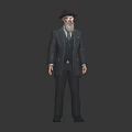 Male Character In Suit With Black Hat Beard And Green Tie Standing Against Dark Background