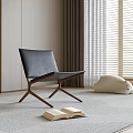 Modern Black Leather Leisure Chair With Wooden Legs And Open Book Near Window Blinds