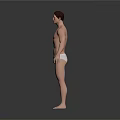Shirtless Muscular Man With Toned Physique In White Underwear On Grey Background