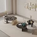 Modern Coffee Tables Set On Light Rug With Decorative Wall Art And Plant Vases