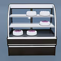 Three Tiered Black White Kitchen Appliance Display Case With Curved Glass And White Cakes