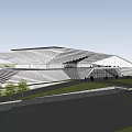Modern Museum Building With Geometric Sloped Roof And Glass Facade In Grass Field