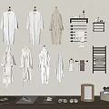 Soft White Robes Hanging On Wall With Towel Racks And Toiletries
