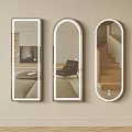 Three Decorative Mirrors Rectangular Arched Oval on Beige Wall Reflecting Living Room Chair Staircase