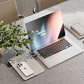 Modern Laptop Setup With Phone Tablet Mouse And Notebook Near Green Plant On Gray Desk