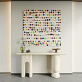 Colorful Polka Dot Painting Above White Console Table With Vase Camera And Decorative Object