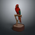 Vibrant Red Parrot with Green Wings Perched on Branch with Sand Base
