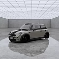 Small Silver Gray Car with Black Roof and Black Wheels in Spacious Modern Indoor Space