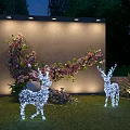 Outdoor Night Decorative Scene With Lighted Deer Ornaments And Flower Wall On Lawn