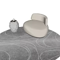 Cream Velvet Single Seater Sofa With Circular Design And Silver Geometric Vase On Gray Carpet
