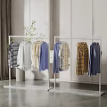 Two Modern Metal Clothes Racks Displaying Various Shirts In Minimalist Room