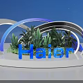Illuminated Haier Brand Display With Curved Structures Green Plants And Blue Background