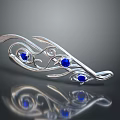 Elegant Silver Brooch Featuring Blue Gemstones And Intricate Curved Floral Design