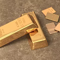Precious Pure Gold Jewelry Featuring Shiny Gold Bars And Small Gold Pieces On Textured Surface