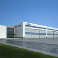 Industrial Factory Building With Aircraft On Tarmac And Metal Roof Structure