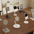 Various Modern Phone Stands With Different Designs On Wooden Table