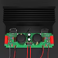 Green Electronic Circuit Board With Capacitors Heat Sink And Red Wires