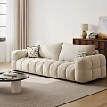 Beige Three Seater Sofa With Accent Pillows Coffee Table And Wooden Cabinet
