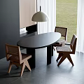 Oval Black Wooden Dining Table And Wicker Back Chairs Near Window With Pendant Light
