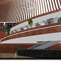 Modern Cinema Interior Design With Multi Level Lobby Glass Railings And Green Plants