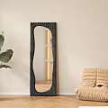 Full Length Irregular Black Mirror In Minimalist Interior With Plant And Bean Bag