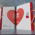 Giant Open Book Installation With Red Heart Shape And Poetry Text For People Interaction