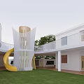 White School Building Featuring Colorful Circular Decor Balcony Rainbow Railings Outdoor Playground Green Lawn Trees