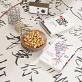 Decorative Ornament Set With Peanut Bowl Books Metal Grid Golden Rack On Calligraphy Pattern Surface