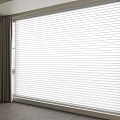White Window Blinds With Gray Curtains Filtering Natural Light In Modern Room