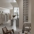 Modern Clothing Store Interior With Sofa Plant Counter And Display Shelves