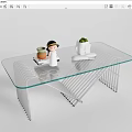 Modern Glass Top Coffee Table With Metal Frame And Small Decor Items And Potted Plant