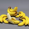 Fresh Ripe Yellow Banana Bunches With a Peeled One on Gray Background
