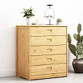 Natural Wooden Chest of Drawers Against White Wall with Potted Plants and Ornaments