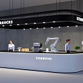 Starbucks Bar Area Featuring Robotic Arms Staff And Modern Counter Setup