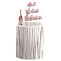 Pink Champagne Bottle With Decorated Wine Glasses On Fringed Round Table