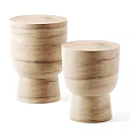 Two Natural Wood Side Tables With Smooth Round Tops And Elegant Curved Bases