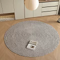 Gray Woven Round Area Rug On Wooden Floor With Modern Furniture And Lamp
