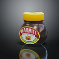 Marmite Yeast Extract Jar With Yellow Lid On Black Reflective Surface