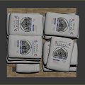 White Household Product Bags Stacked on Wooden Pallet With Labels and Patterns
