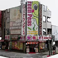 Cartoon Style Commercial Street Scene With Vibrant Billboards Green Peas Signs And Japanese Characters