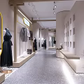 Modern Clothing Store Interior With Clothing Displays Decorative Plants And Lighting Fixtures